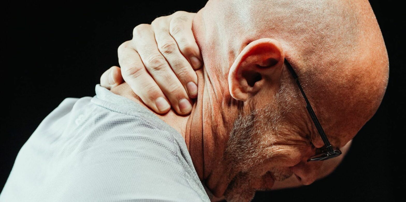 close up photo of a man having a neck pain